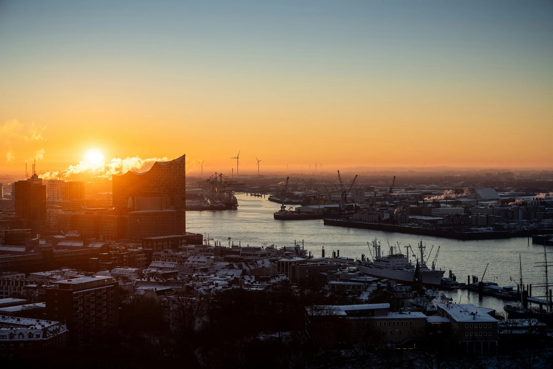 Construction cranes over a city skyline